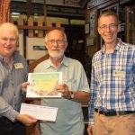 2018.07.27 Paul Conibeare, WSR General Manager, presents Williton Station Master John Parsons with the 2018 runner up certificate in the Best Kept Station Competition, organised by WSR Chairman Ian Coleby (right). © Jacquie Green.