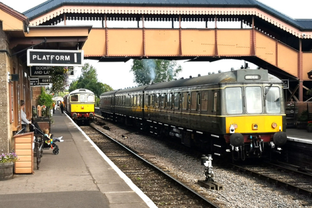 2019.07.31. The 09:55 DOWN to Minehead on UP Platform 2 at Williton, allows a special from Washford to use DOWN Platform 1. The Washford to Norton Fitzwarren train consisted of a rake of vintage rolling stock. © Richard Salt.