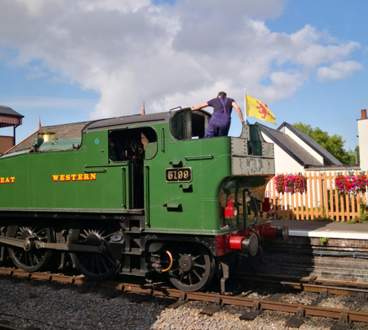 2023.07.12. The fireman moves coal forward from the bunker on GWR Large Prairie Tank No 5199 ready for the climb up to Sogumber Station. (The Somerset flag is in the garden not on the coal bunker!) © Richard Salt.